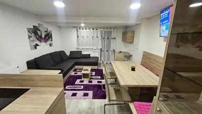 a living room with a couch and a table at App DA-LI SPORT KOPE in Slovenj Gradec