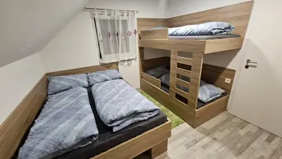 a small bedroom with a bed and a bunk room at App DA-LI SPORT KOPE in Slovenj Gradec