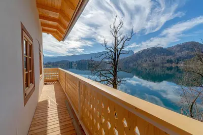 a balcony with a view of a lake at Lake Bled Apartments in Bled