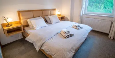 a bedroom with a bed with towels on it at Lake Bled Apartments in Bled