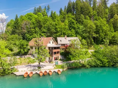 an aerial view of a house next to a lake at Lake Bled Apartments in Bled