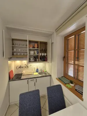 a kitchen with two blue chairs and a sink at Marjetica 40 in Moravske Toplice