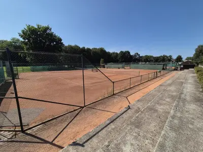 a tennis court with a net on a tennis court at Marjetica 40 in Moravske Toplice