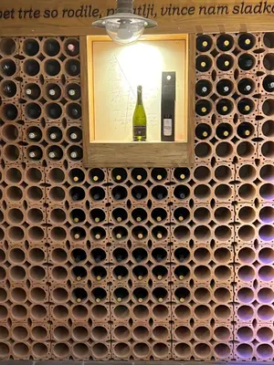 a wall of wine bottles in a wine cellar at Luxury House Ledine in Spodnja Idrija