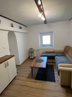 a living room with a couch and a table at Luxury House Ledine in Spodnja Idrija