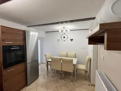 a kitchen and dining room with a table and chairs at Luxury House Ledine in Spodnja Idrija