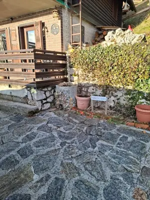 a bench sitting in front of a house at Apartma Maya in Cerklje na Gorenjskem