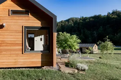 a building with a window on the side of it at Posestvo Brida - Glamping in Ilirska Bistrica
