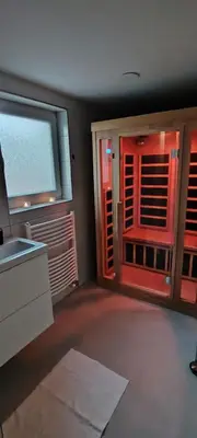 a room with a kitchen with a window and a sink at Mini wellness studio-near the airport in Smlednik
