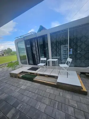 two white chairs sitting on a patio in a house at mobile house Rest Area in Ljubljana