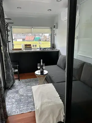 a living room with a couch and a table at mobile house Rest Area in Ljubljana