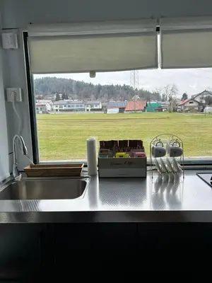 a kitchen counter with a sink and a window at mobile house Rest Area in Ljubljana