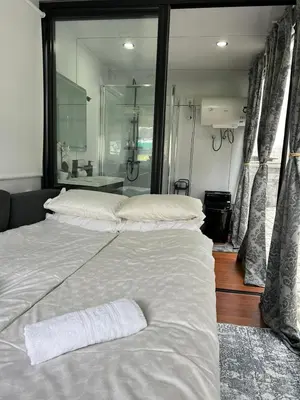 a bedroom with a large white bed with a mirror at mobile house Rest Area in Ljubljana