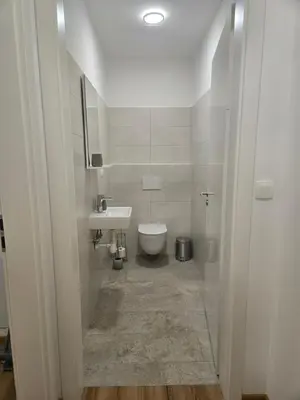 a bathroom with a toilet and a sink at Agregat in Ljubljana