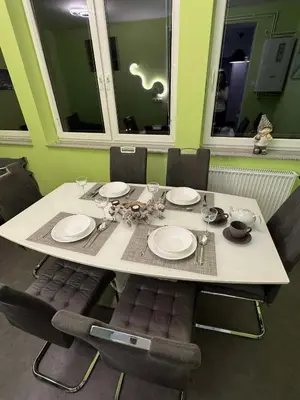 a white table with chairs and plates at Blue Sky Apartment in Bled