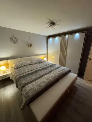 a bedroom with a bed and a ceiling fan at Blue Sky Apartment in Bled