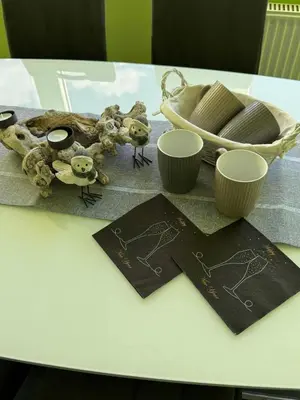 a table with two cards and two cups on it at Blue Sky Apartment in Bled