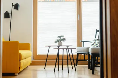 a living room with a table and chairs and a window at Nordic House Apartment A1 in Kranjska Gora