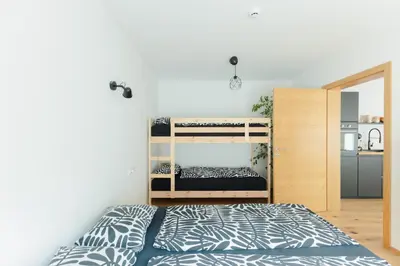 a bedroom with a bed and bunk beds at Nordic House Apartment A1 in Kranjska Gora