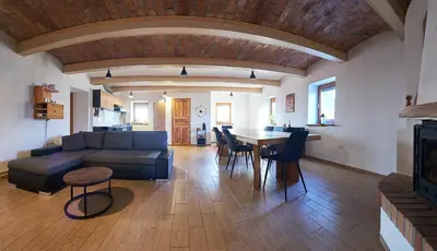 a living room with a couch and a table at Hisa na Zlatem polju in Lukovica pri Domžalah