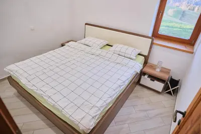 a bed in a small room with a window at Hisa na Zlatem polju in Lukovica pri Domžalah
