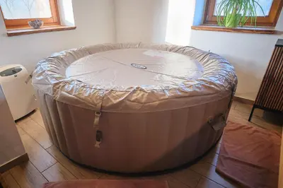 a large tub sitting on the floor in a room at Hisa na Zlatem polju in Lukovica pri Domžalah