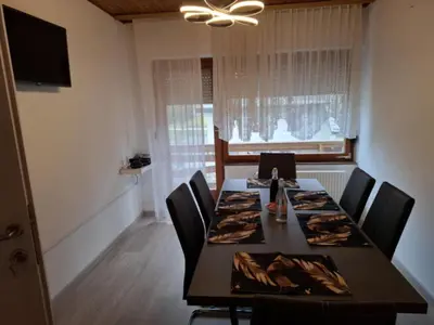 a dining room with a long table and chairs at Apartmaji PRI JUNESKO in Kranjska Gora