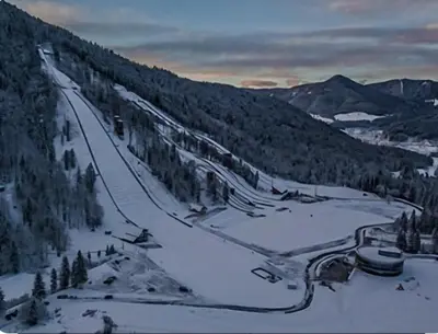 a view of a ski slope with snow and trees at Apartmaji PRI JUNESKO in Kranjska Gora