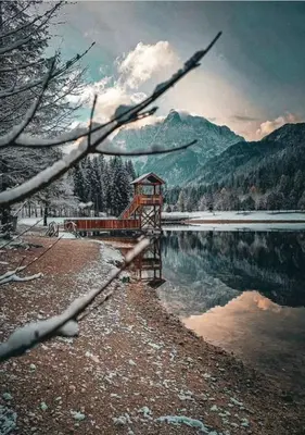 a bridge over a body of water with a mountain at Apartment Misty Forest in Kranjska Gora