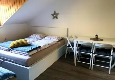 a bedroom with a bed and a table with a desk at Apartment Misty Forest in Kranjska Gora