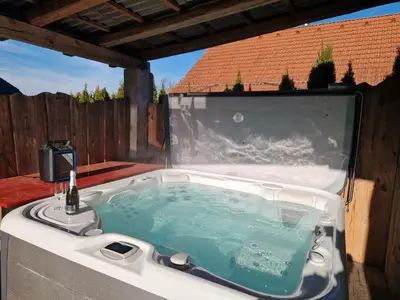 a bath tub sitting on top of a patio at Kmečka Vila in Višnja Gora