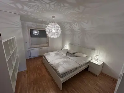 a bedroom with a bed and a chandelier at Cozy stay near Bled in Radovljica