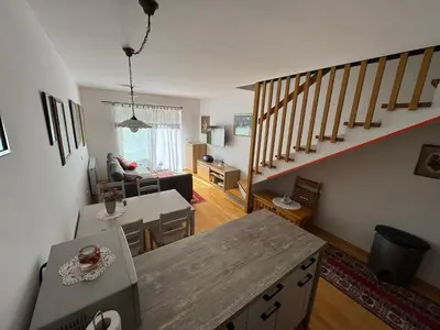 a living room with a staircase and a living room at Apartment MANCA-HOLIN in Bohinj