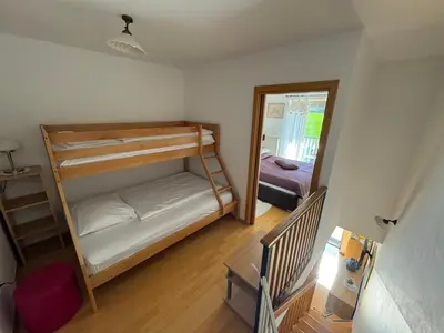 a small room with two bunk beds and a mirror at Apartment MANCA-HOLIN in Bohinj