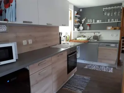 a kitchen with white cabinets and a stove top oven at Cottage Stela Bohinj in Bohinj