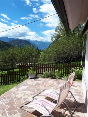 a couple of chairs sitting on a patio at Cottage Stela Bohinj in Bohinj