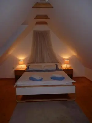 a bedroom with a bed with two pillows on it at Chalet Bovec in Bovec