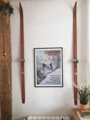 a wall with a picture and two skis on it at Chalet Bovec in Bovec