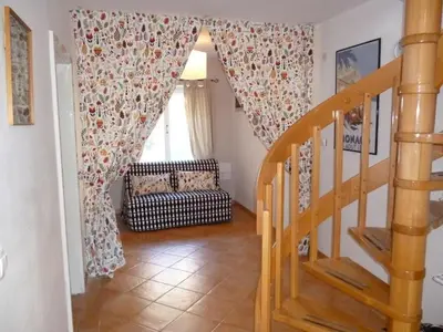 a staircase in a house with a chair and a window at Chalet Bovec in Bovec