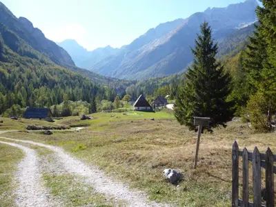 a dirt road in a field with mountains in the background at Chalet Bovec in Bovec