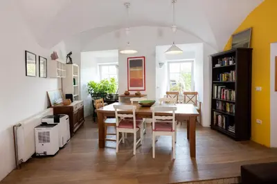 a kitchen and dining room with a table and chairs at Hiša Linhart Apartment in Radovljica