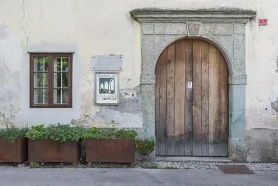 a large wooden door on the side of a building at Hiša Linhart Apartment in Radovljica