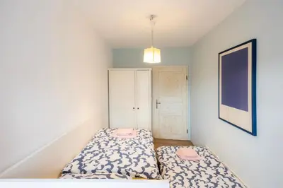 a small bedroom with two beds and a cabinet at Hiša Linhart Apartment in Radovljica