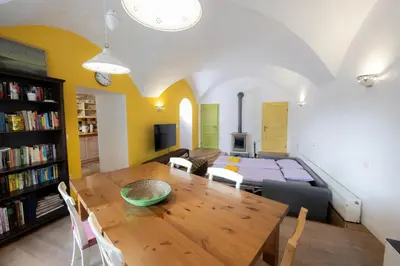 a living room with a table and a dining room at Hiša Linhart Apartment in Radovljica