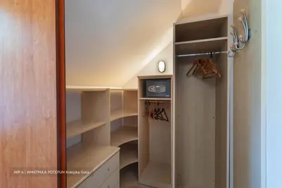 a walk in closet with a glass door at Apartmaji Potepuh in Kranjska Gora