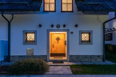 a yellow door on the side of a building at Apartmaji Potepuh in Kranjska Gora
