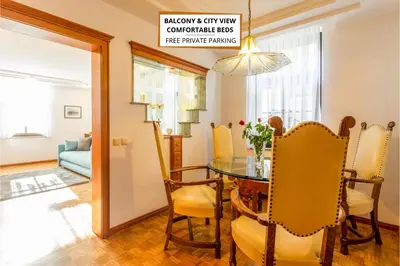 a dining room with a glass table and yellow chairs at Apartma Apolon I in Krško