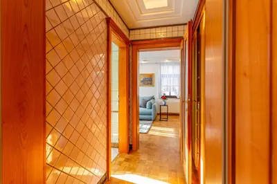 a hallway with a door leading to a living room at Apartma Apolon I in Krško