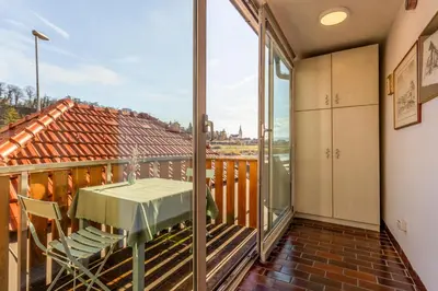 a balcony with a table and chairs and a view at Apartma Apolon I in Krško