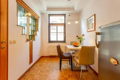 a kitchen with a table and chairs and a window at Apartma Apolon I in Krško